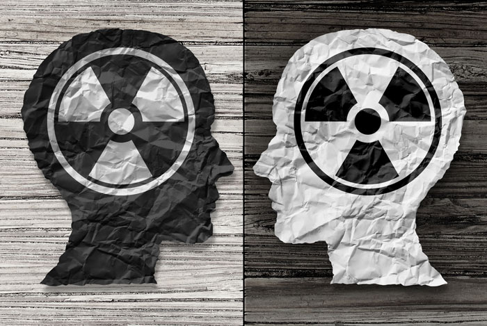 black and grey illustration of two heads with radiation symbol on them - toxic relationships