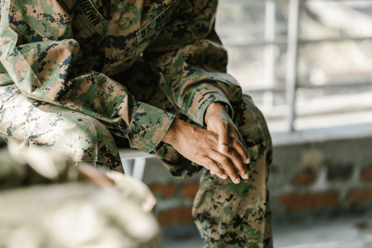 soldier sitting in a chair - veterans