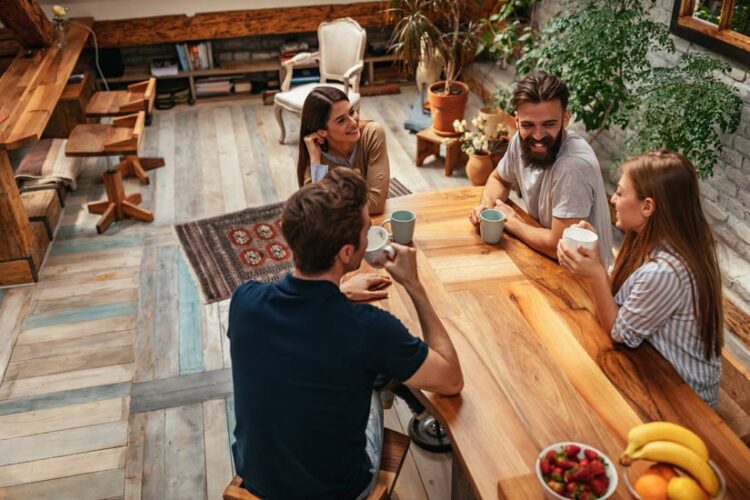 group of four friends visiting over coffee at a table in a cafe or restaurant - misconceptions