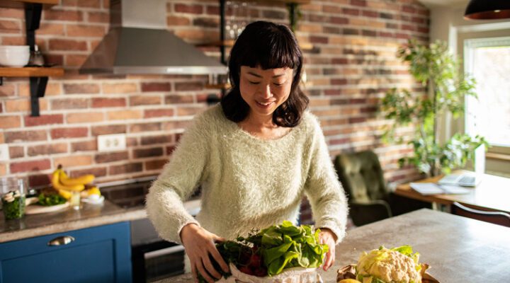 woman in her kitchen preparing a healthy meal