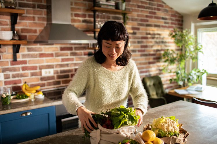 woman in her kitchen preparing a healthy meal