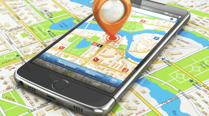 Image of a GPS app on a phone on top of a map.