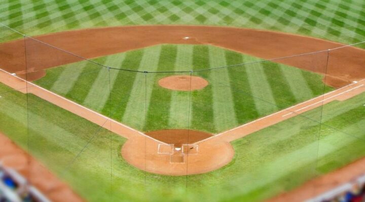 An overhead view of a baseball field, showing the infield, home plate, and neatly mowed grass patterns.